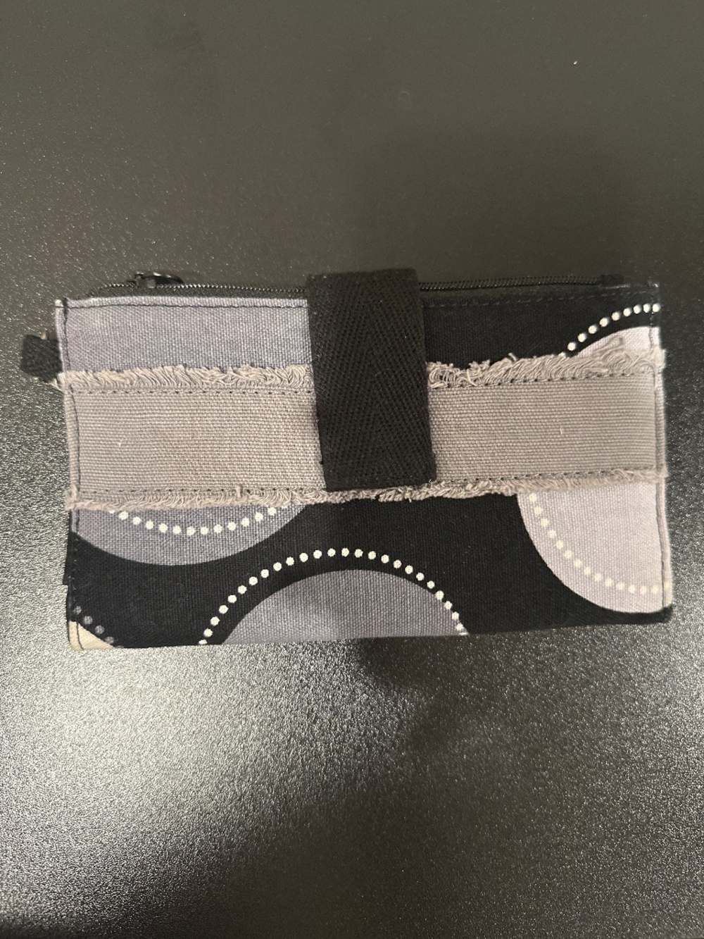Black, white and grey soft sided wallet